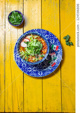 Delicious Pozole soup served in a colorful bowl with fresh toppings for Mexican Independence Day Delicious Pozole soup served in a colorful bowl with fresh toppings for Mexican Independence Day 124598806