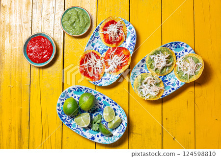 Delicious Mexican chalupas served with vibrant sauces and fresh limes 124598810