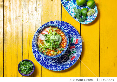 Delicious tortilla fried Aztec soup paired with fresh toppings and festive decorations for Cinco de Mayo celebrations Delicious tortilla fried Aztec soup paired with fresh toppings and festive decorations for Cinco de Mayo celebrations 124598825