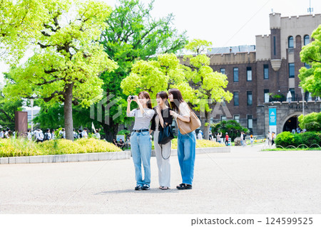 Girls' trip A young woman sightseeing at Osaka Castle Park with a camera Girls' trip A young woman sightseeing at Osaka Castle Park with a camera 124599525