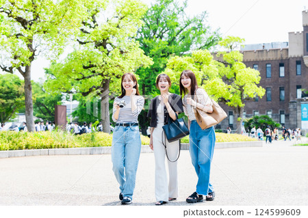 Girls' trip A young woman sightseeing at Osaka Castle Park with a camera Girls' trip A young woman sightseeing at Osaka Castle Park with a camera 124599609