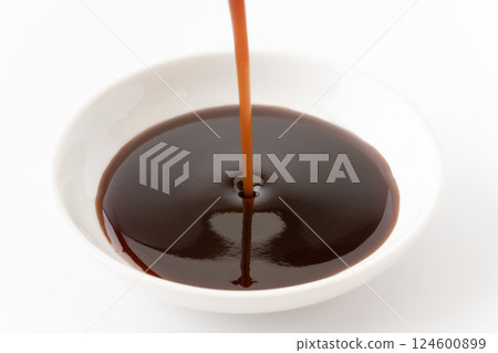 Pouring medium-thick sauce into a small dish Pouring medium-thick sauce into a small dish 124600899