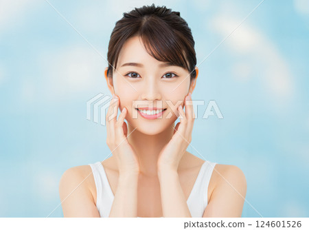 Beauty image of a young woman smiling with her hands on her cheeks 124601526