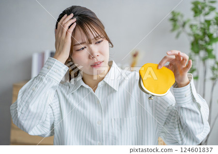 Woman holding a wallet, lack of money, saving Woman holding a wallet, lack of money, saving 124601837