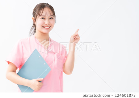 Healthcare worker in pointing pose Healthcare worker in pointing pose 124601872