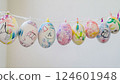 Children's Easter egg decorations hanging on a string Colorful painted eggs for spring holiday 124601948