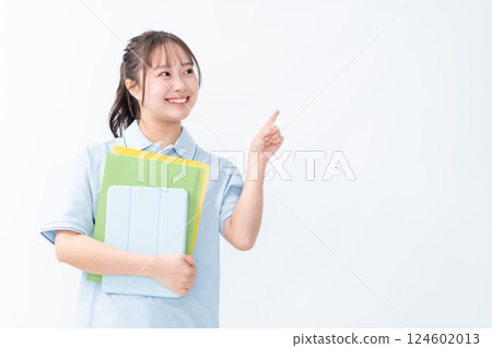 A female student in a polo shirt pointing at something 124602013