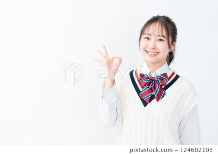 High school girl making an OK pose on a white background High school girl making an OK pose on a white background 124602103