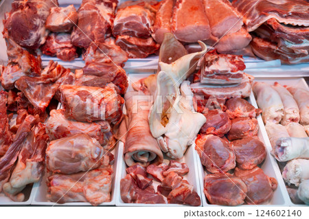 Variety meat in packing tray on glass window refrigerator of butcher shop. 124602140