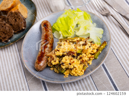Grilled sausage and scrambled eggs with mushrooms for breakfast Grilled sausage and scrambled eggs with mushrooms for breakfast 124602159