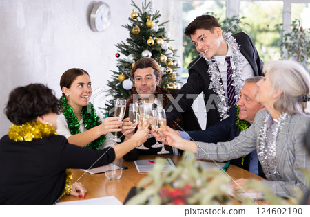 Portrait of professional business team delighted with achievements of joint work on eve of Christmas 124602190