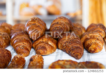 Tasty croissants with delicate and juicy filling. Pastries are stacked standing on showcase Tasty croissants with delicate and juicy filling. Pastries are stacked standing on showcase 124602253