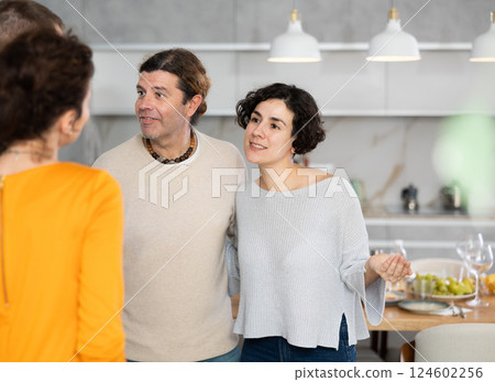 Husband and wife stand side by side and say goodbye to guests 124602256