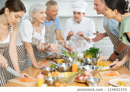 Professional personal chef cook in customer private kitchen house giving cooking lesson to people at home Professional personal chef cook in customer private kitchen house giving cooking lesson to people at home 124602350