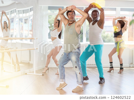 Group of men and women dancing in studio Group of men and women dancing in studio 124602522