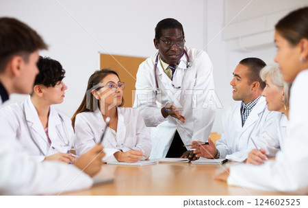 African American professor of medicine giving lecture to group of internship doctors 124602525