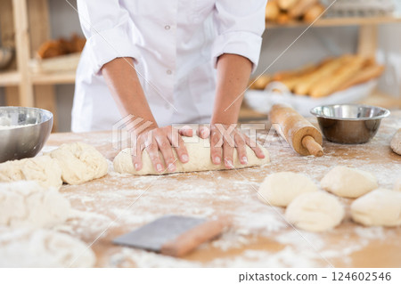 Chef working with dough in a bakery Chef working with dough in a bakery 124602546