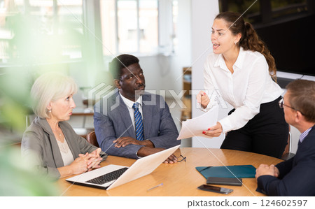 Group of different people arguing at table in office Group of different people arguing at table in office 124602597