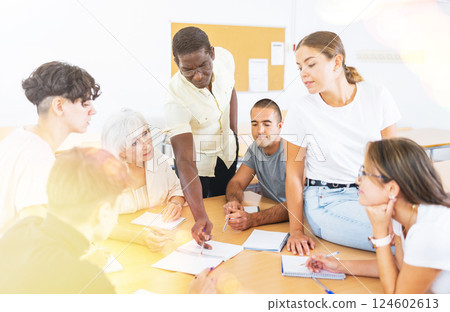 People of different ages communicating in speaking club with African American teacher 124602613