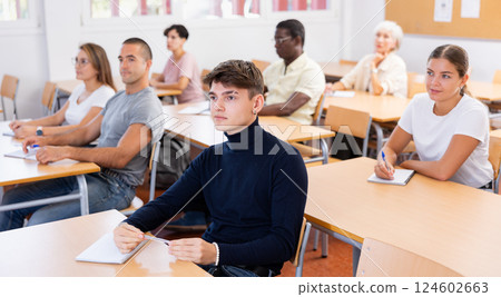 Focused guy attending foreign languages courses for adults 124602663
