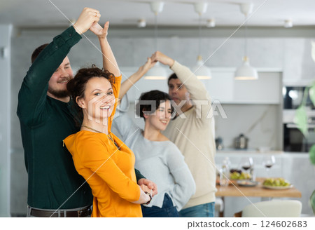 Men and women dancing during house party. 124602683