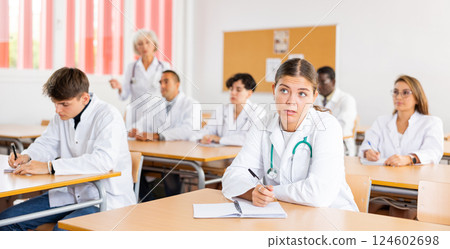 Young female student listening to lecture during professional medical training 124602698