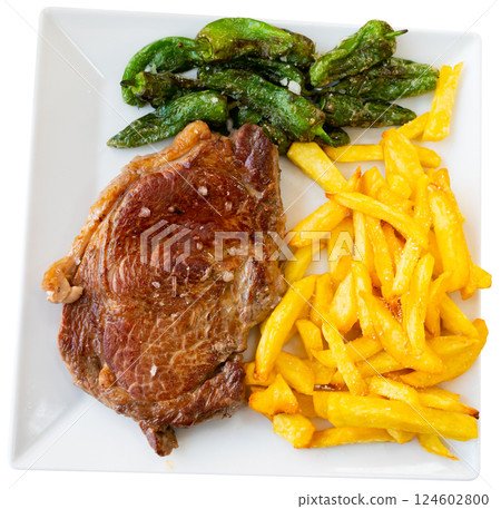 Grilled beef garnished with French fries and baked green pepper. 124602800