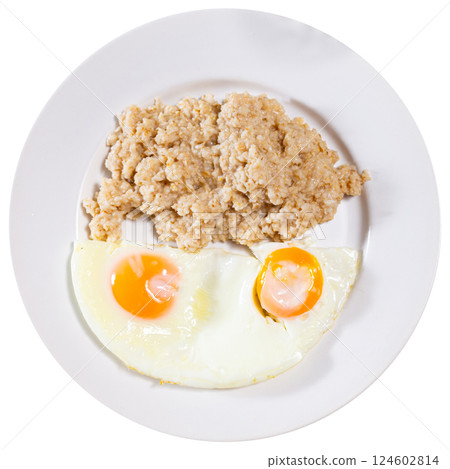 Breakfast with scrambled eggs and oatmeal with butter closeup 124602814