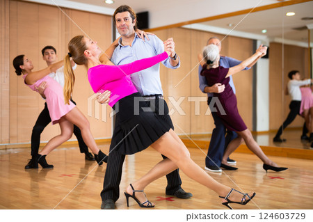 Woman and man dancing slow ballroom dance in choreography studio Woman and man dancing slow ballroom dance in choreography studio 124603729