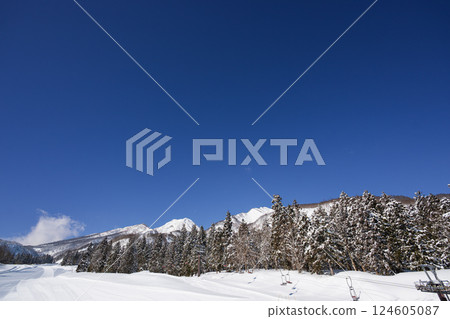 A sunny winter morning at a ski resort after the slopes have been groomed 124605087