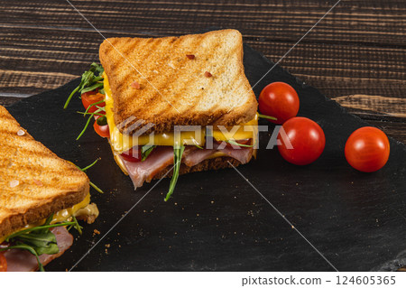 Grilled cheese sandwich with ham, spinach, and tomatoes on toast Grilled cheese sandwich with ham, spinach, and tomatoes on toast 124605365