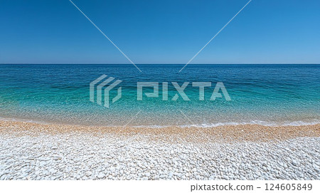 A serene beach with clear turquoise waters and a pristine sandy shore under a bright sky. 124605849