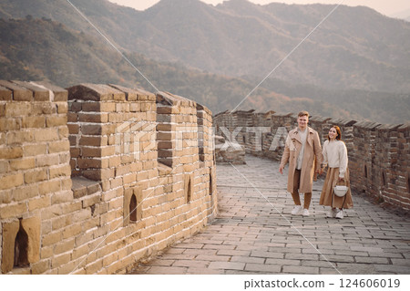 young couple running and twirling at the Great Wall of China. Newly married couple on their honeymoon to the Great Wall of China near Beijing China. young couple running and twirling at the Great Wall of China. Newly married couple on their honeymoon to the Great Wall of China near Beijing China. 124606019