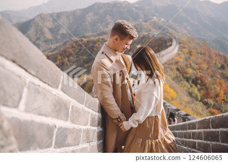beautiful young couple showing affection on the Great Wall of China. Newly married couple on their honemoon to Great Wall near Beijing China. Stylish couple exploring one of the wonders of the world 124606065