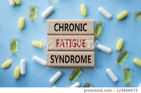 Chronic Fatigue Syndrome symbol. Concept word Chronic Fatigue Syndrome on wooden blocks. Beautiful blue background with pills. Medicine and Chronic Fatigue Syndrome concept. Copy space Chronic Fatigue Syndrome symbol. Concept word Chronic Fatigue Syndrome on wooden blocks. Beautiful blue background with pills. Medicine and Chronic Fatigue Syndrome concept. Copy space 124606073
