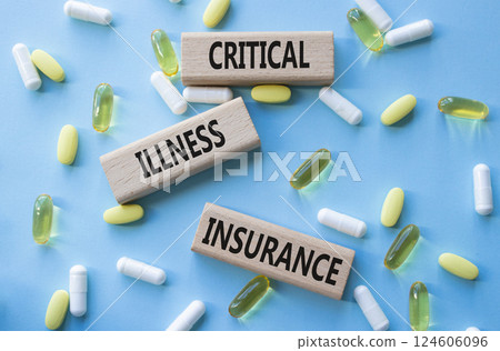 Critical Illness Insurance symbol. Concept word Critical Illness Insurance on wooden blocks. Beautiful blue background with pills. Medicine and Critical Illness Insurance concept. Copy space 124606096