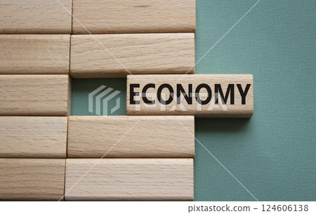 Economy symbol. Concept word Economy on wooden blocks. Beautiful grey green background. Business and Economy concept. Copy space. 124606138