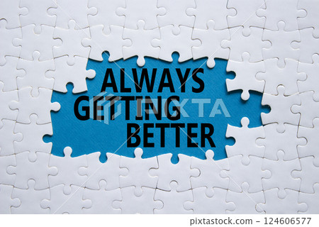 Always getting better symbol. White puzzle with words Always getting better. Beautiful blue background. Business and Always getting better concept. Copy space. 124606577