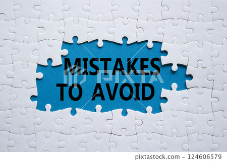 Mistakes symbol. Concept words Mistakes to Avoid on white puzzle. Beautiful blue background Business and Mistakes to Avoid concept. Copy space. 124606579