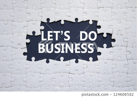 Lets do business symbol. Concept words Lets do business on white puzzle. Beautiful deep blue background. Business and Lets do business concept. Copy space. 124606582