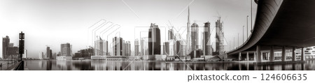 Skyscrapers and bridge over water, black and white style, city background, Dubai Marina bay UAE 124606635