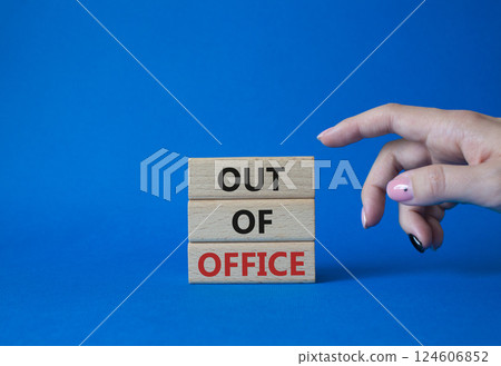 Out of Office symbol. Concept words Out of Office on wooden blocks. Businessman hand. Beautiful blue background. Business and Out of Office concept. Copy space Out of Office symbol. Concept words Out of Office on wooden blocks. Businessman hand. Beautiful blue background. Business and Out of Office concept. Copy space 124606852