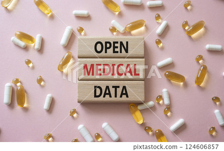 Open Medical Data symbol. Concept word Open Medical Data on wooden blocks. Beautiful pink background with pills. Medicine and Open Medical Data concept. Copy space 124606857