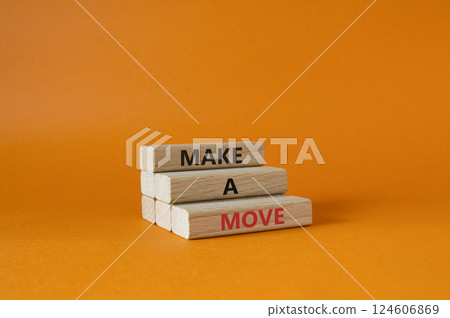 Make a Move symbol. Concept words Make a Move on wooden blocks. Beautiful orange background. Business and Make a Move concept. Copy space. 124606869