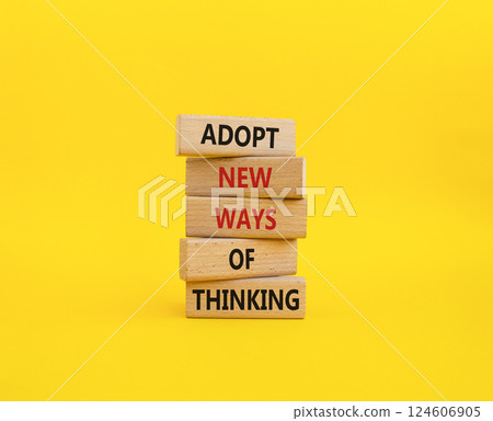 Adopt new ways of thinking symbol. Wooden blocks with words Adopt new ways of thinking. Beautiful yellow background. Business and Adopt new ways of thinking concept. Copy space. 124606905