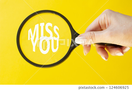 Miss you symbol. Magnifying Glass with Concept word Miss you. Beautiful yellow background. Businessman hand. Miss you concept. Copy space Miss you symbol. Magnifying Glass with Concept word Miss you. Beautiful yellow background. Businessman hand. Miss you concept. Copy space 124606925