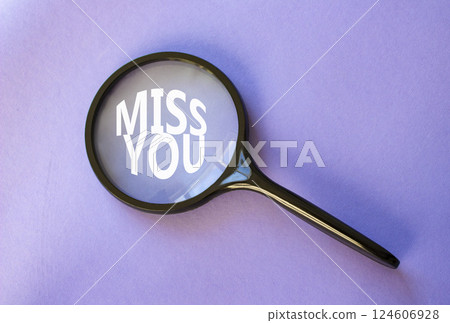 Miss you symbol. Magnifying Glass with Concept word Miss you. Beautiful purple background. Miss you concept. Copy space 124606928