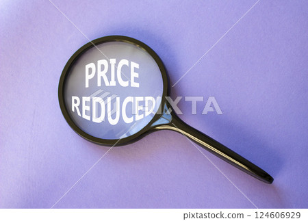 Price reduced symbol. Magnifying Glass with Concept word Price reduced. Beautiful purple background. Business and Price reduced concept. Copy space 124606929