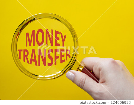 Money Transfer symbol. Magnifying Glass with Concept word Money Transfer. Businessman hand. Beautiful yellow background. Business and Money Transfer concept. Copy space Money Transfer symbol. Magnifying Glass with Concept word Money Transfer. Businessman hand. Beautiful yellow background. Business and Money Transfer concept. Copy space 124606933