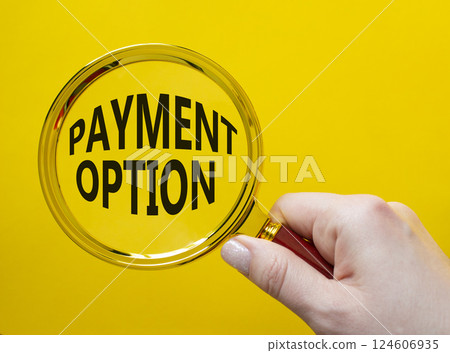 Payment Option symbol. Concept words Payment Option on magnifying glass. Businessman hand. Beautiful yellow background. Business and Payment Option concept. Copy space. Payment Option symbol. Concept words Payment Option on magnifying glass. Businessman hand. Beautiful yellow background. Business and Payment Option concept. Copy space. 124606935